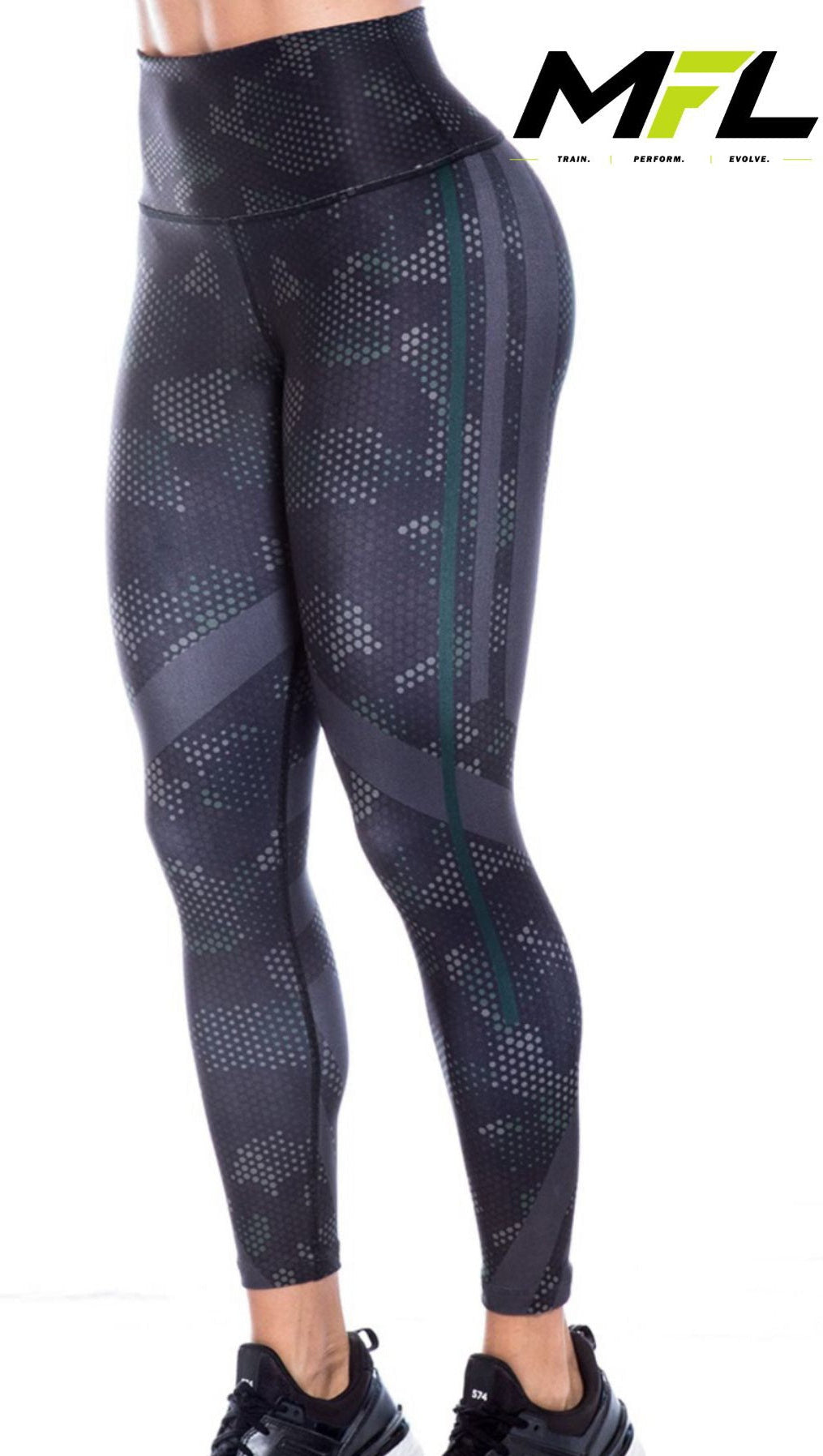 Woman wearing Carbon Edge Leggings with gray and hint of green pattern while posing sideways 