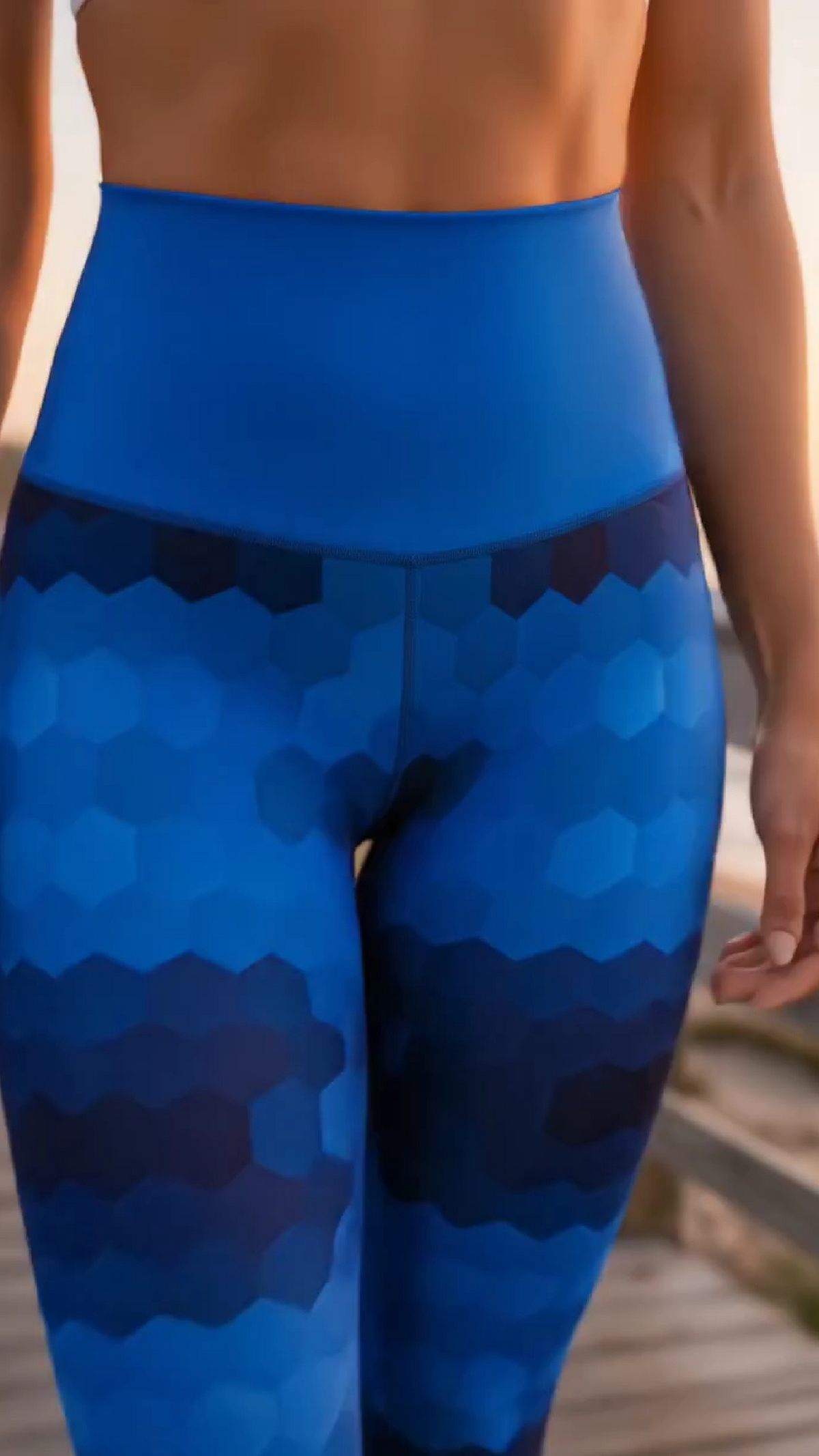 Woman wearing Ocean Hex Leggings showing her front waist